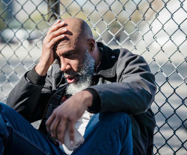 Man stretching outdoors at sunrise, feeling energized and full of life.